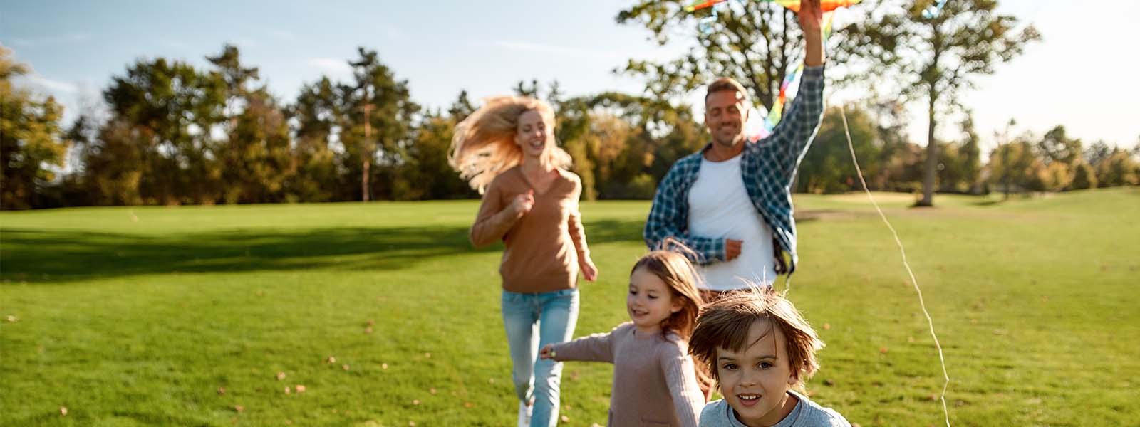 family running with kite