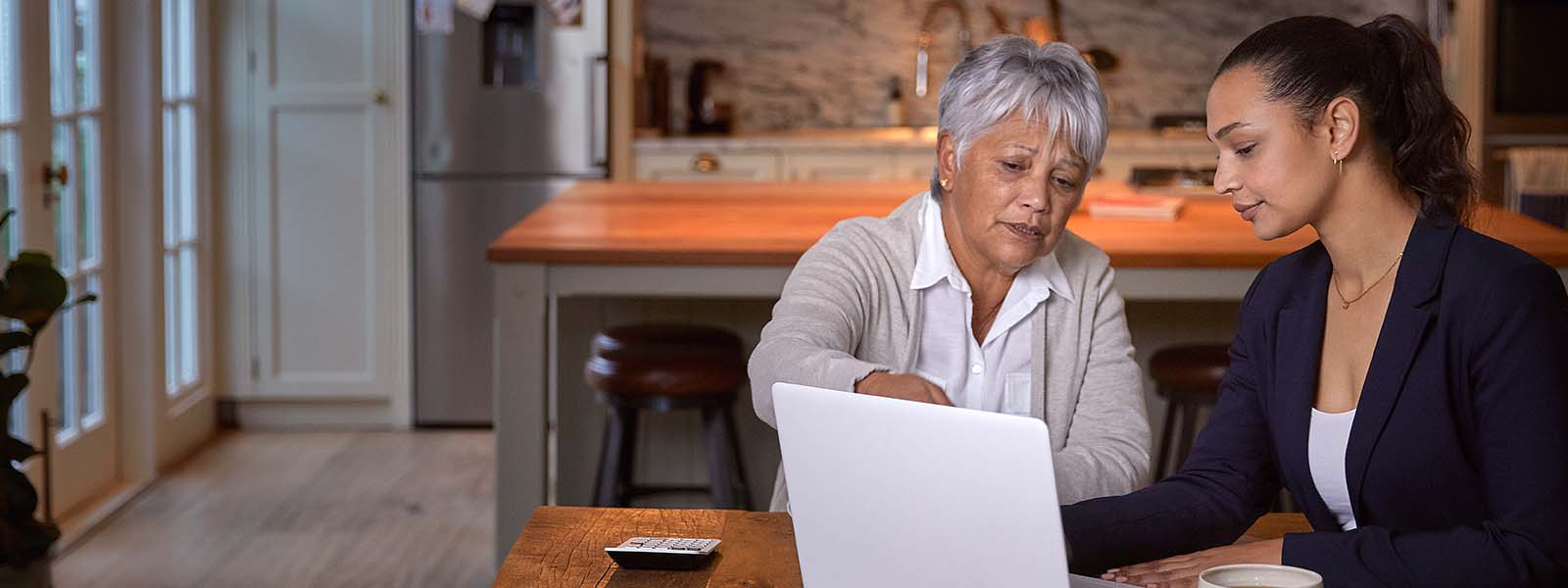 mother daughter looking at computer 